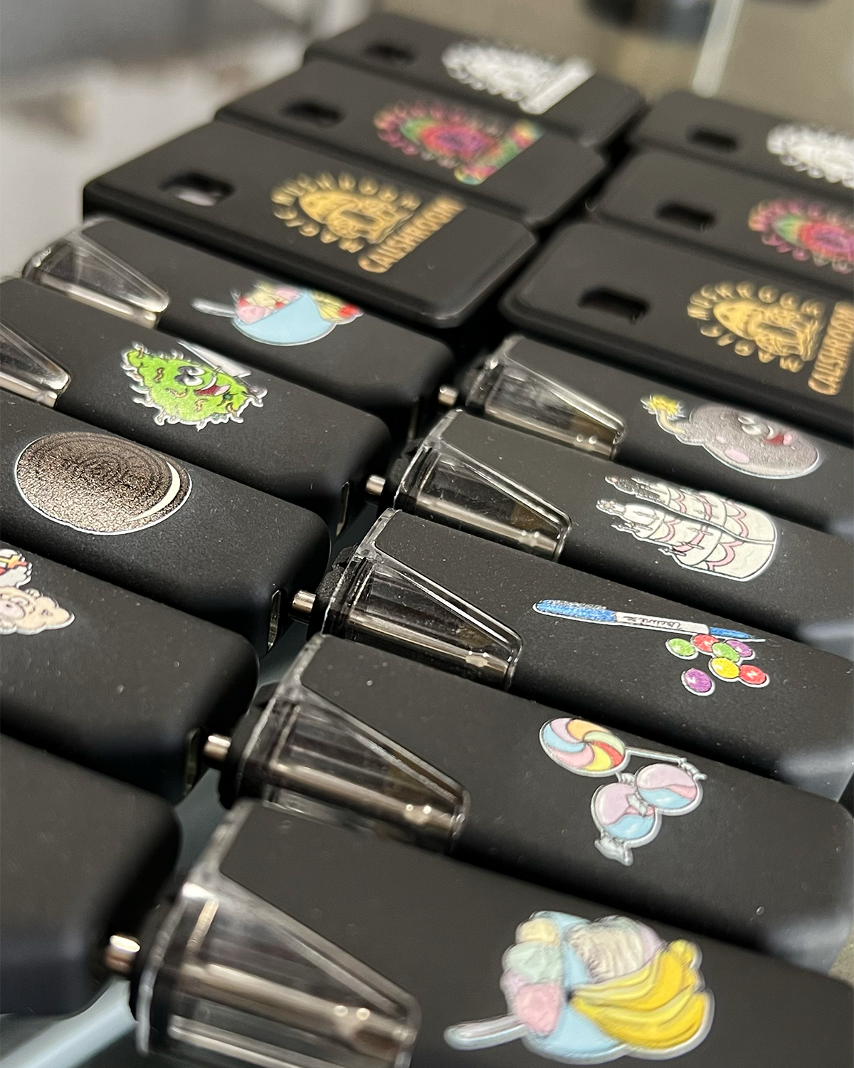 Black iKrusher vape devices featuring custom direct-printed colorful graphics.
